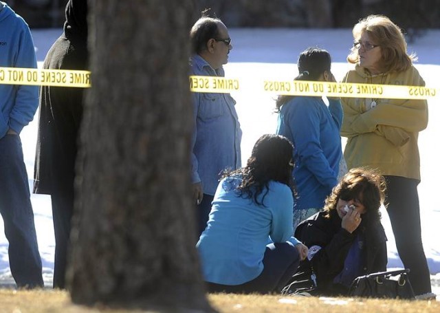 Friends and neighbors react outside a townhouse complex following an overnight hostage-taking incident in Aurora, Colorado