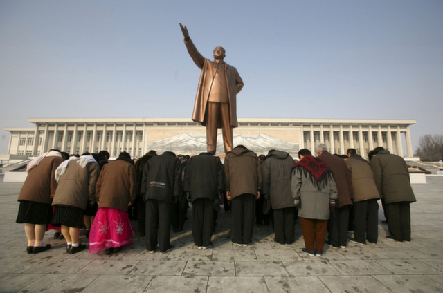 People bow in front of a statue of Kim Il Sung in Pyongyang, North Ko