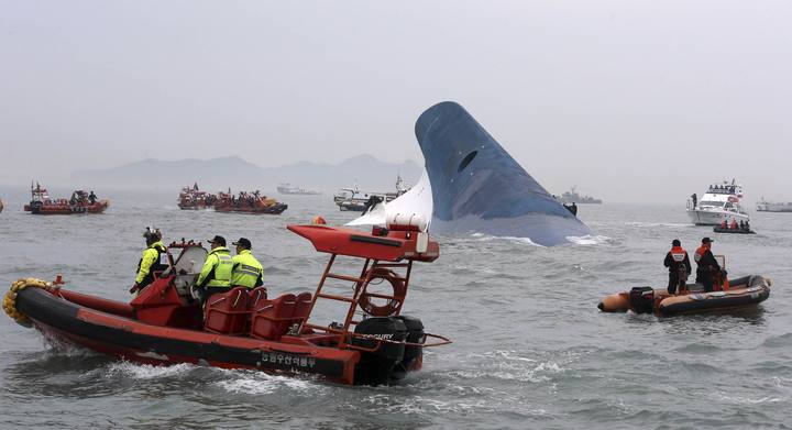 Part of South Korean passenger ship "Sewol" that has been sinking is seen as South Korean maritime policemen search for passengers in the sea off Jindo