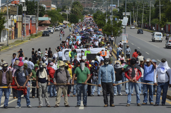 IGUALA, GUERRERO, 22OCTUBRE2014.- Dos presuntos agentes de la Secretaría de Gobernación fueron detenidos en por Profesores integrantes de la Coordinadora Estatal de Trabajadores de la Educación de Guerrero CETEG, UPOEG y estudiantes de la normal rural de Ayotzinapa , así como normalistas de todo el estado, quienes marcharon para exigir la presentación con vida de los 43 estudiantes desaparecidos de Ayotzinapa. Los detenidos marcharon junto con los normalistas descalzos. FOTO: BERNANDINO HERNÁNDEZ /CUARTOSCURO.COM