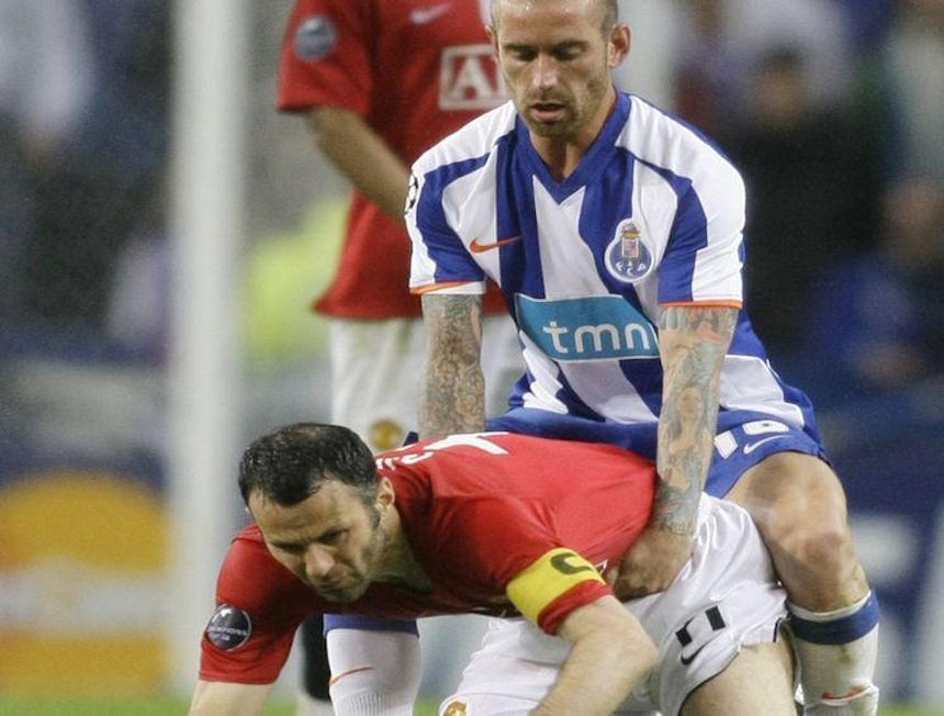 Manchester United's Ryan Giggs is held by Porto's Raul Meireles during their Champions League soccer match in Porto