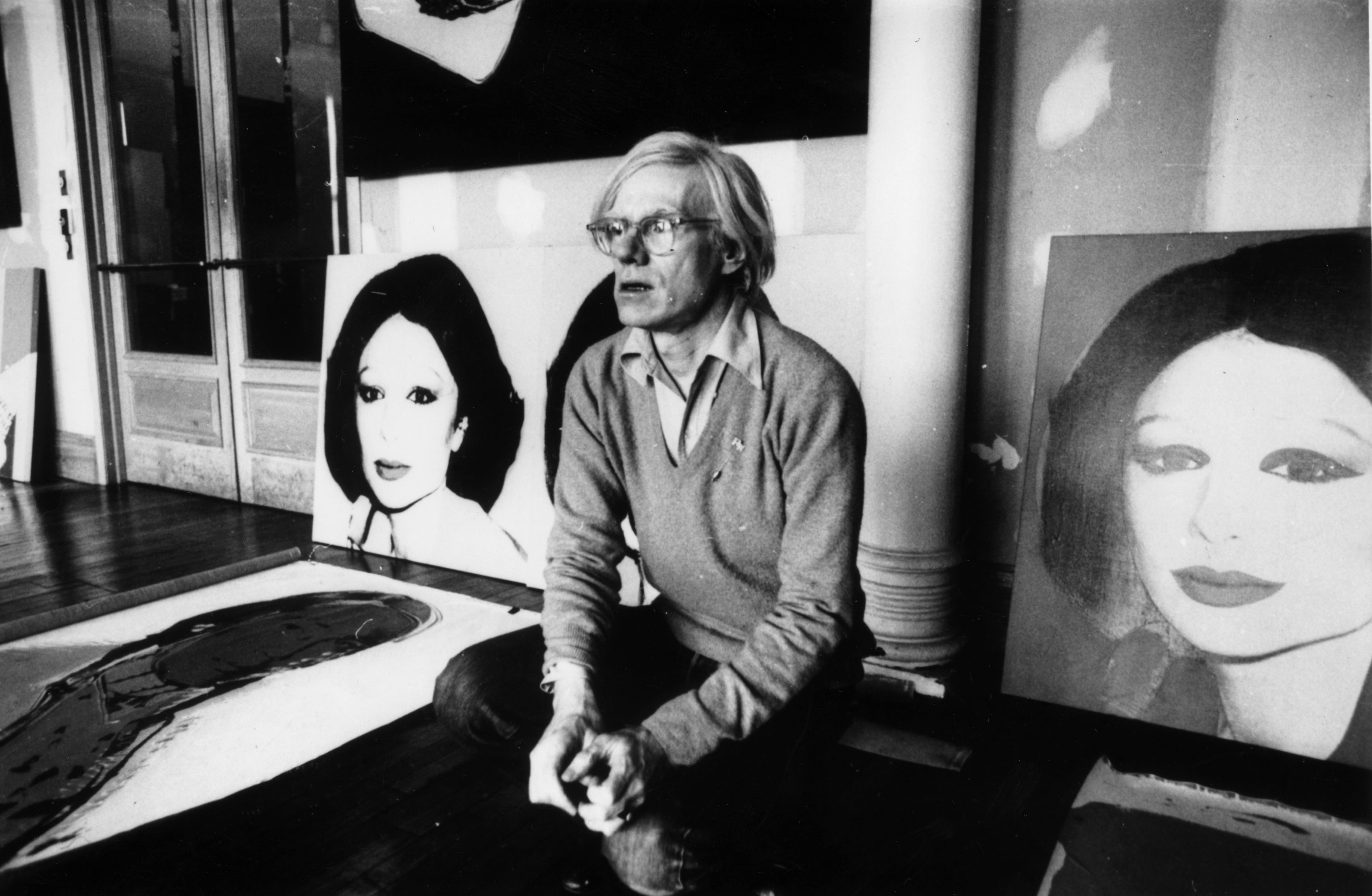 Artist Andy Warhol (1928 - 1987) in New York with his latest work, 'Princess Of Iran'. (Photo by Graham Wood/Getty Images)