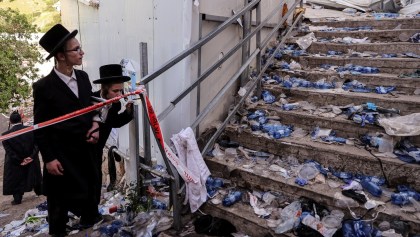 Ultra Orthodox Jews look at stairs with waste on it in Mount Meron, northern Israel, where fatalities were reported among the thousands of ultra-Orthodox Jews gathered at the tomb of a 2nd-century sage for annual commemorations that include all-night prayer and dance, April 30, 2021.