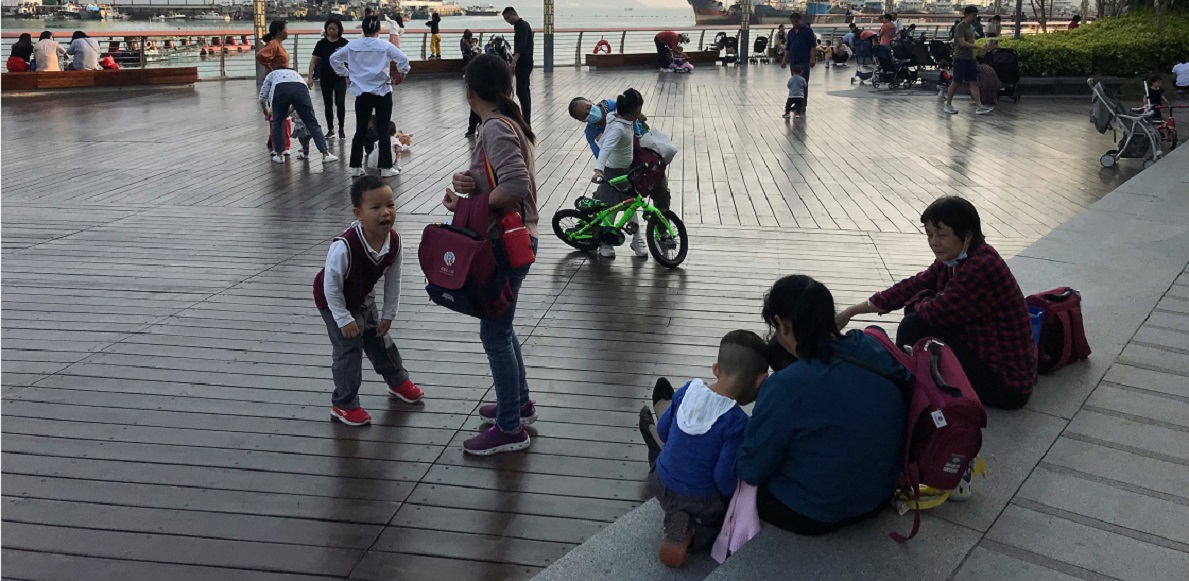 FILE PHOTO: Children play at a waterfront in Shekou area of Shenzhen, Guangdong province, China March 15, 2021.