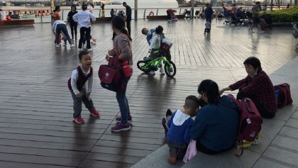 FILE PHOTO: Children play at a waterfront in Shekou area of Shenzhen, Guangdong province, China March 15, 2021.