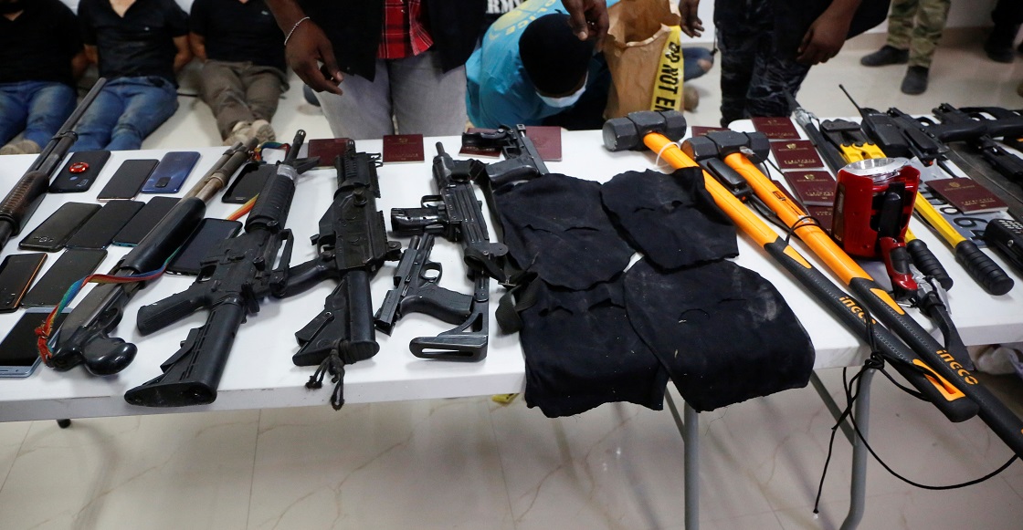 Weaponry, mobile phones, passports and other items are being shown to the media along with suspects in the assassination of President Jovenel Moise, who was shot dead early Wednesday at his home, in Port-au-Prince, Haiti July 8, 2021. 