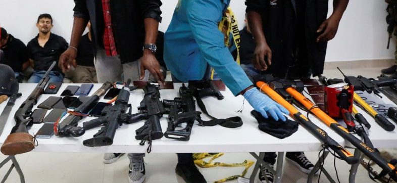 Weaponry, mobile phones, passports and other items are being shown to the media along with suspects in the assassination of President Jovenel Moise, who was shot dead early Wednesday at his home, in Port-au-Prince, Haiti July 8, 2021.