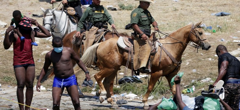 U.S. Border Patrol agents ride horses on the banks of the Rio Grande river, border between Ciudad Acuna, Mexico and Del Rio, Texas, U.S., as migrants seeking refuge into the United States cross the river, in Ciudad Acuna, Mexico September 20, 2021.