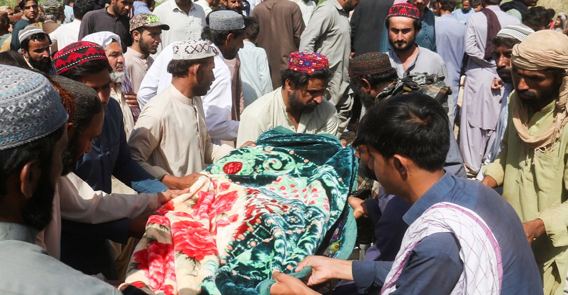 Men carry a body, who was killed following an earthquake, during a funeral in Harnai, Balochistan, Pakistan, October 7, 2021. 