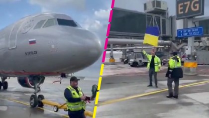 Empleado de aeropuerto da indicaciones a avión ruso con bandera de Ucrania